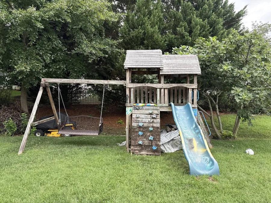 An old wooden playset in a fenced Richmond back yard, with our text reply: firm price sent, Thursday 2pm