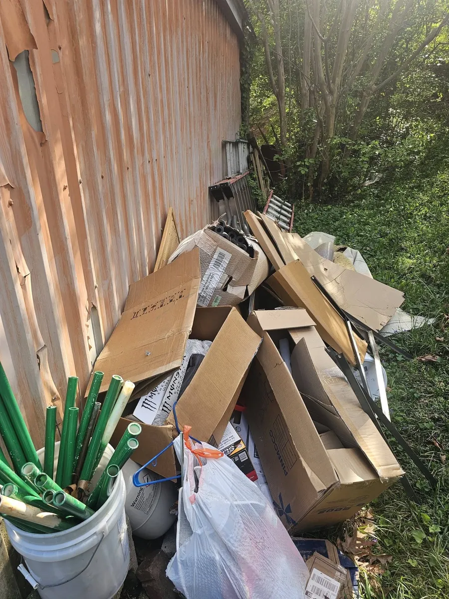 Debris piled along the side of a shed in a Richmond back yard